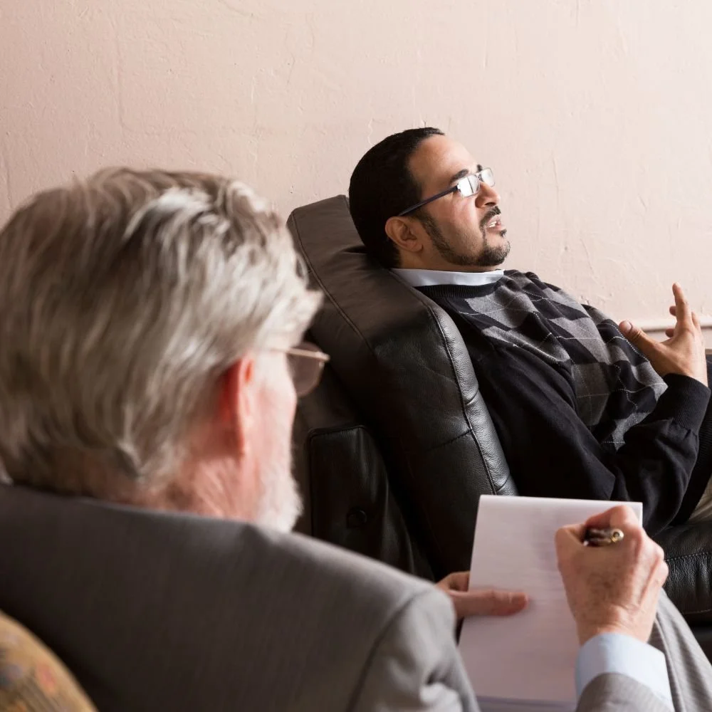 Man lying on couch talking to therapist