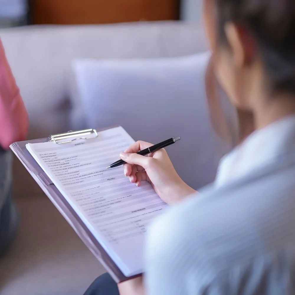 Close-up of therapist filling out a form