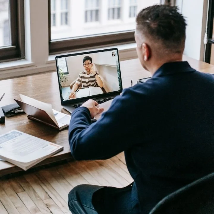 Adult attending a telehealth psychology appointment with a psychologist through a secure video call.