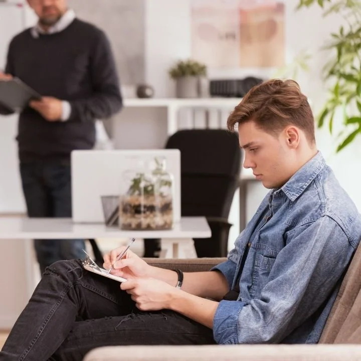 Client completing paperwork before an online psychological evaluation.