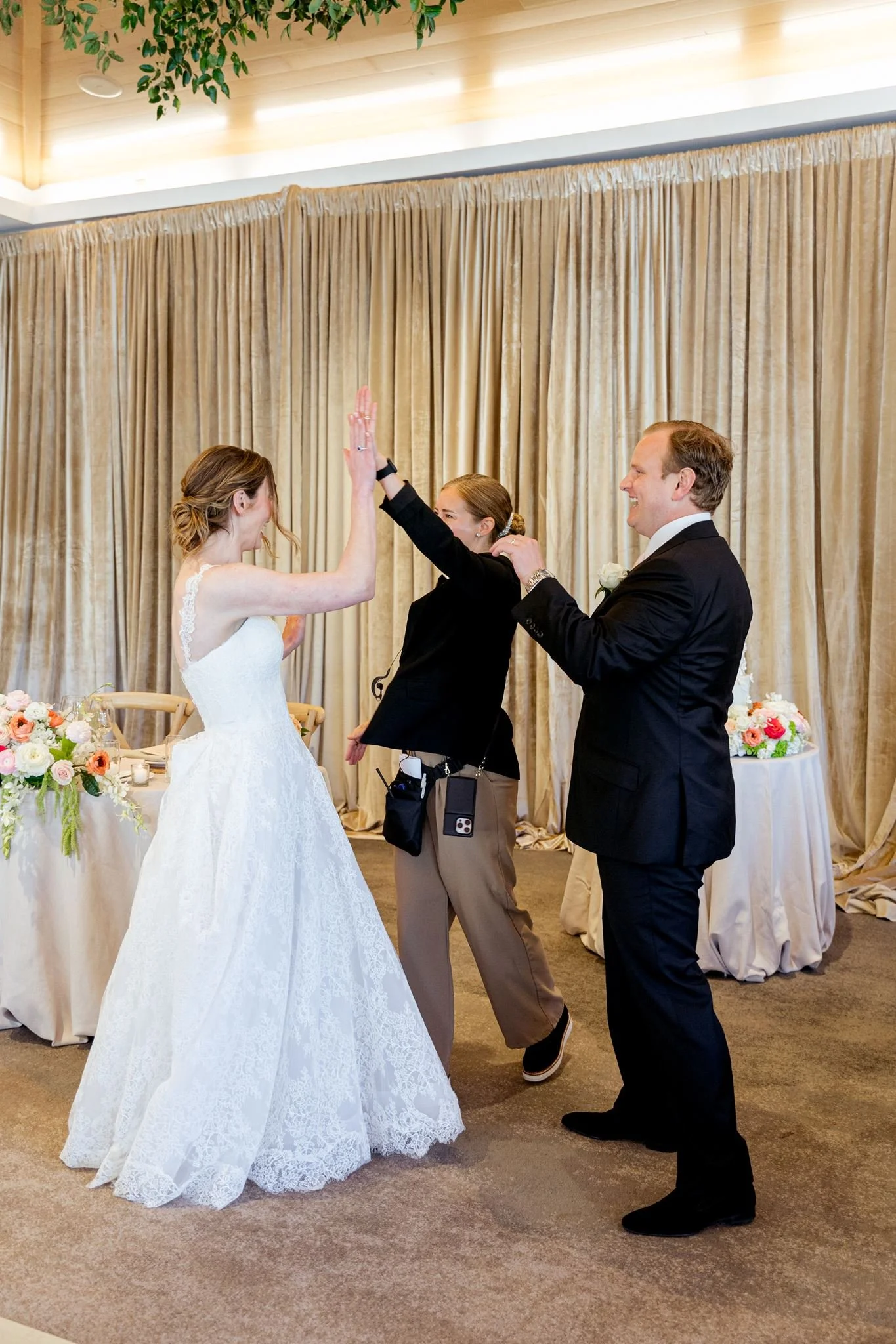 Wedding planner coordinating a bride and groom during their reception at a Carmel wedding venue.
