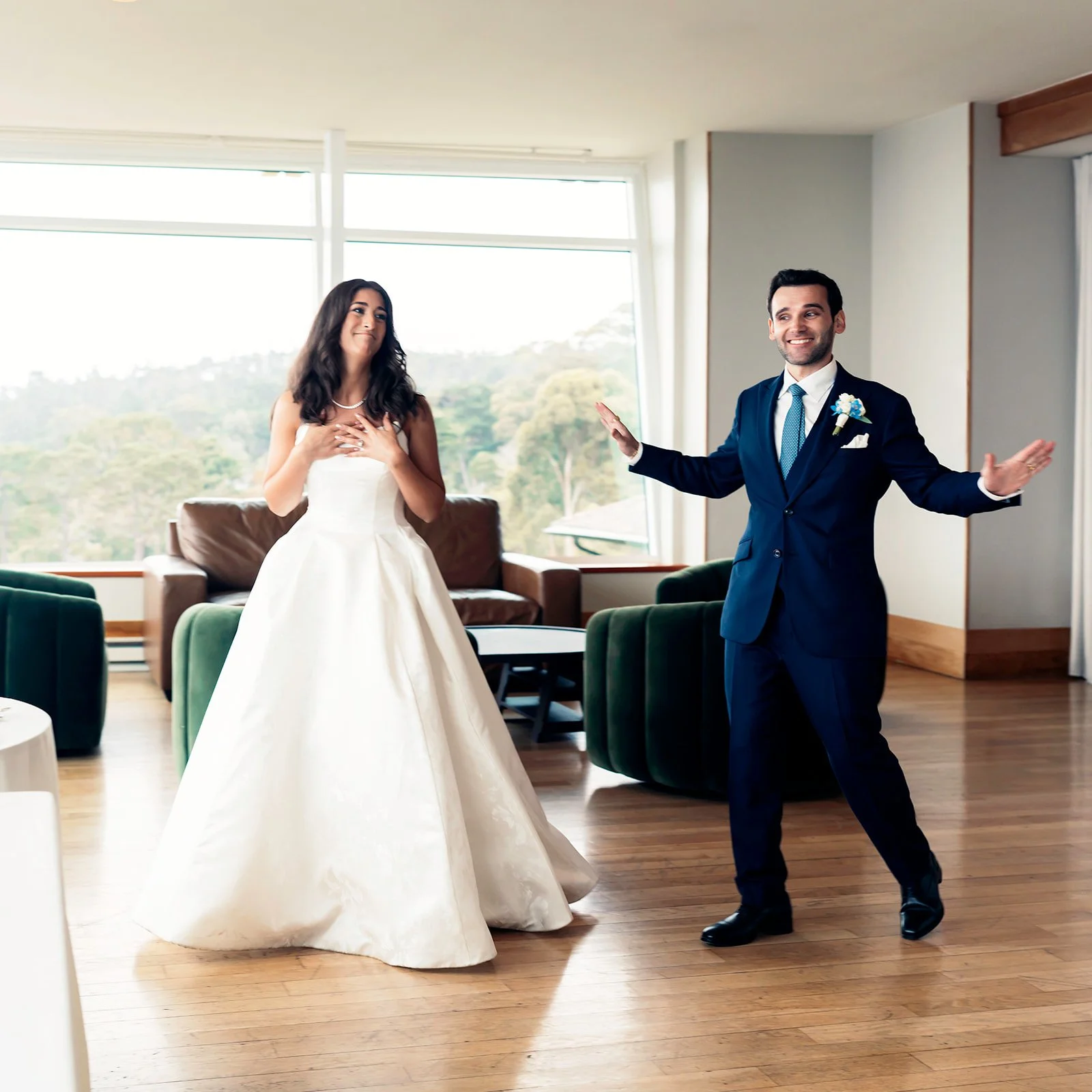 Bride and groom share an emotional first look inside Highlands Inn in Carmel, California, before their wedding ceremony.