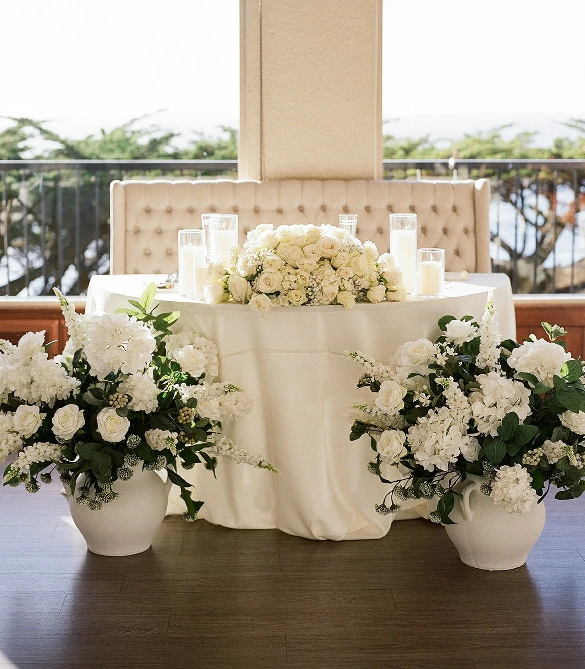 Wedding sweetheart table with white flowers, candles, and elegant décor.