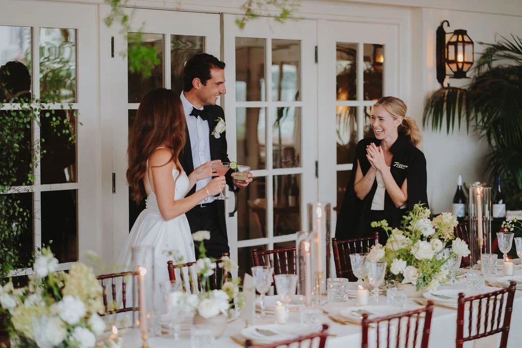 Wedding Couple smiling at Owner, standing over their table
