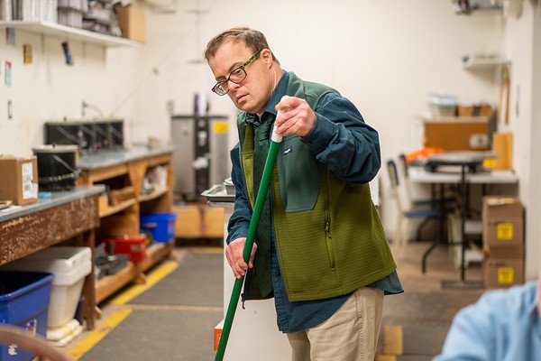 Man sweeping the floor of Candleland. (Copy)