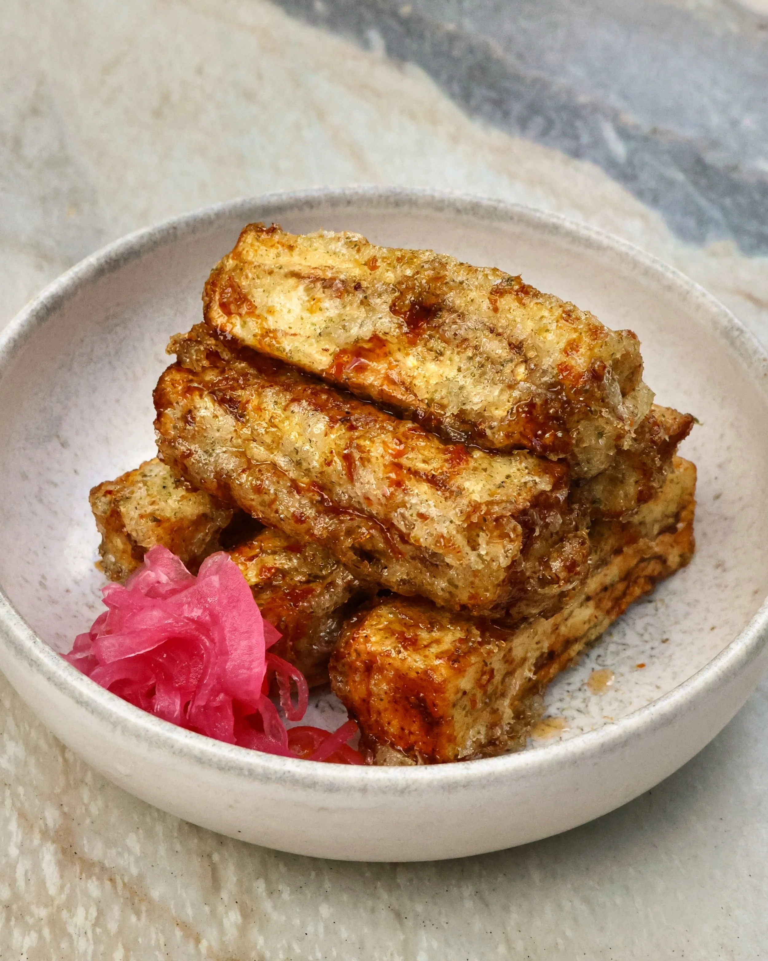 Irresistible, sweet and salty, perfectly crisp on the outside and tender on the inside. The perfect starter or side, our fried eggplant with ginger soy