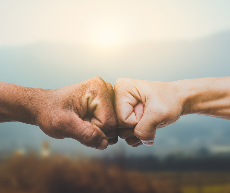 two male hands fist bumping
