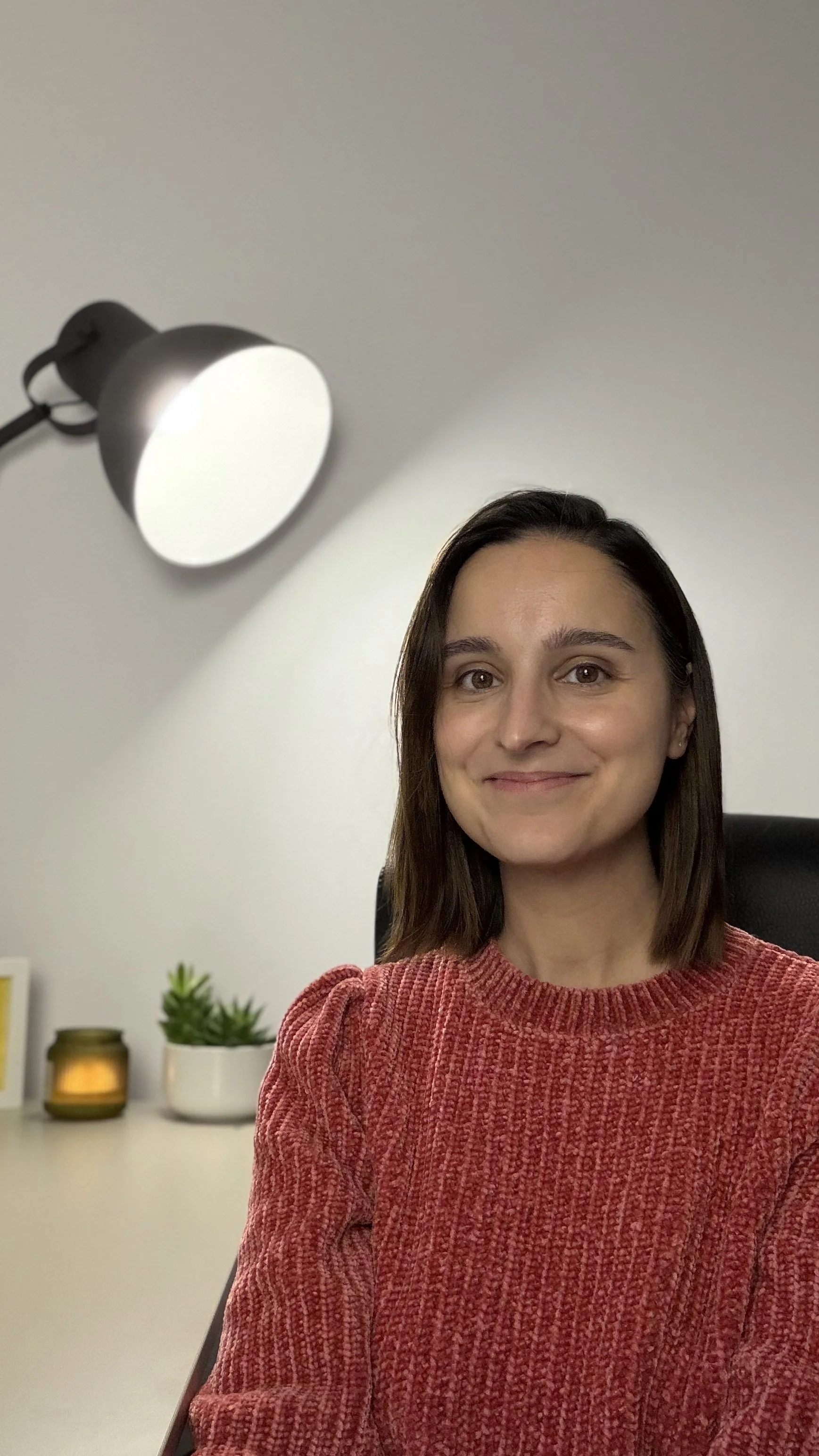 Bilyana sitting at her desk, smiling