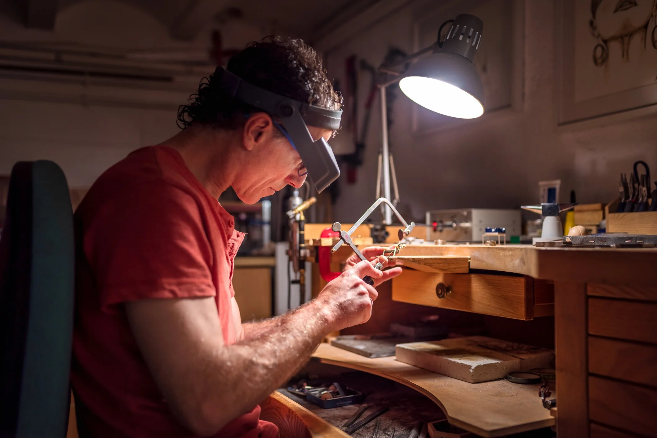 A man working in a workshop under artificial light