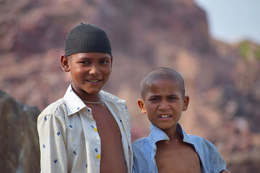 Two boys smiling in the mountains