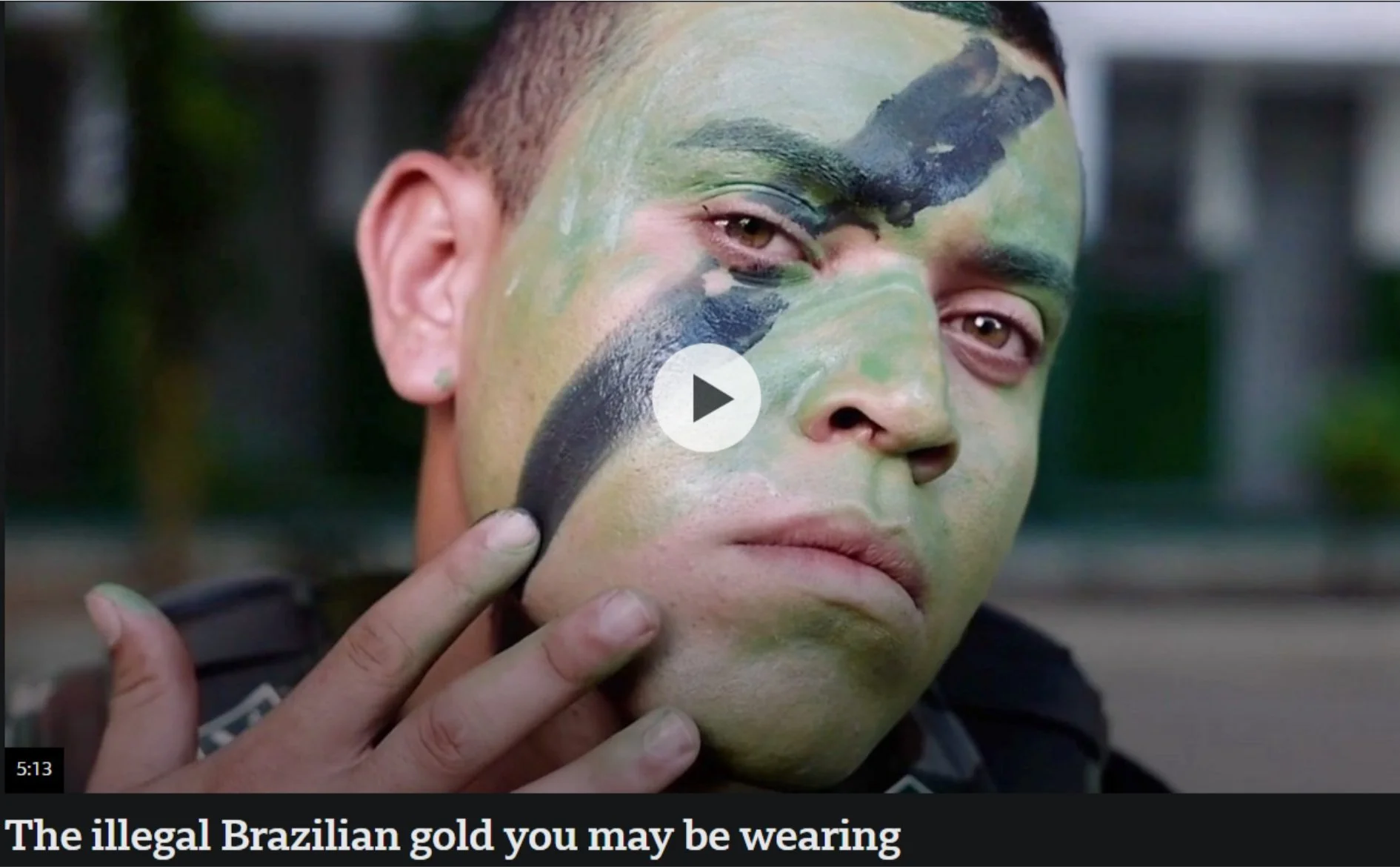 An indigenous man with green and black paint on his face