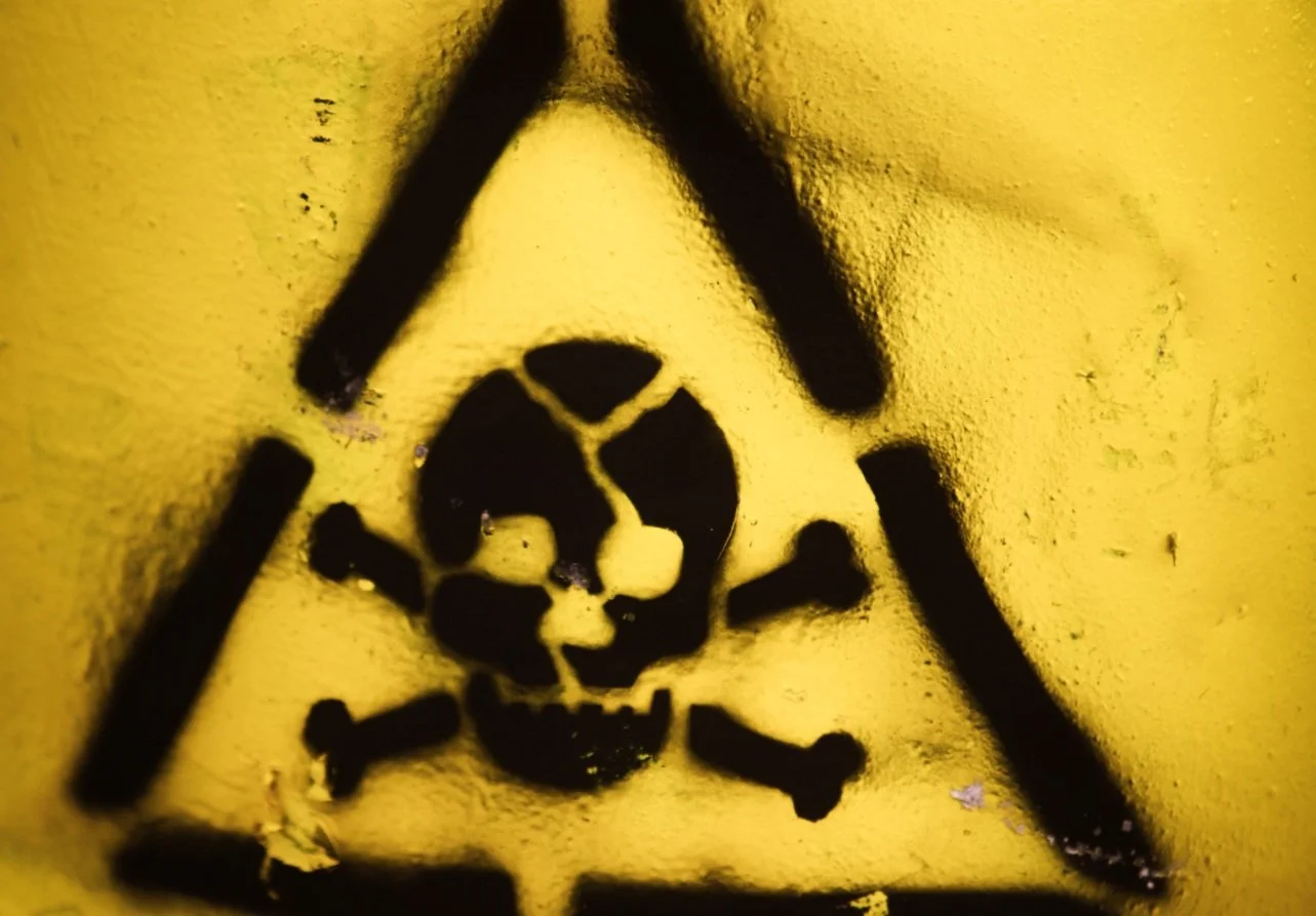 A triangular skull warning sign