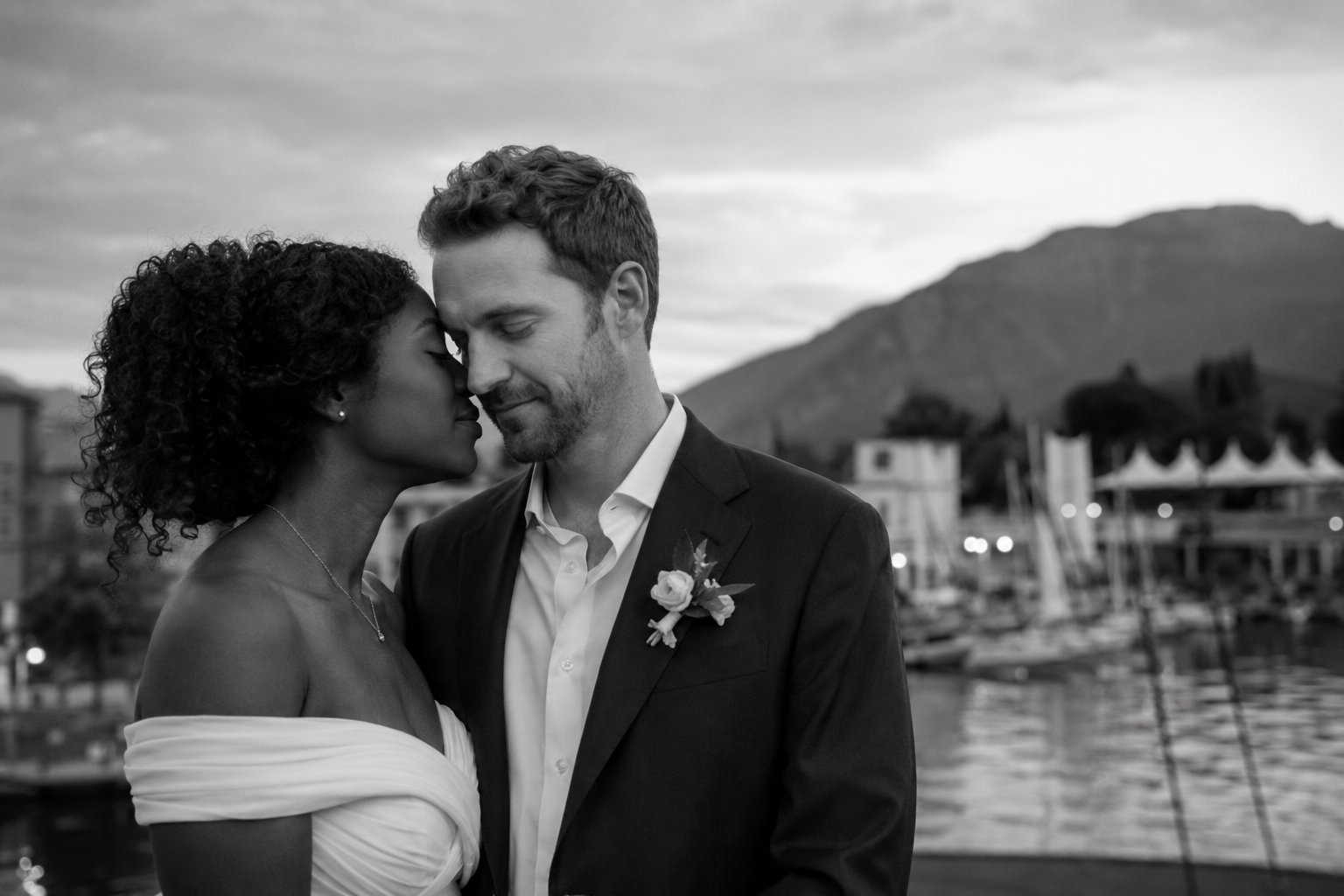 Bride and groom during a romantic wedding portrait session in Riva del Garda with Lake Garda and the mountains in the background.