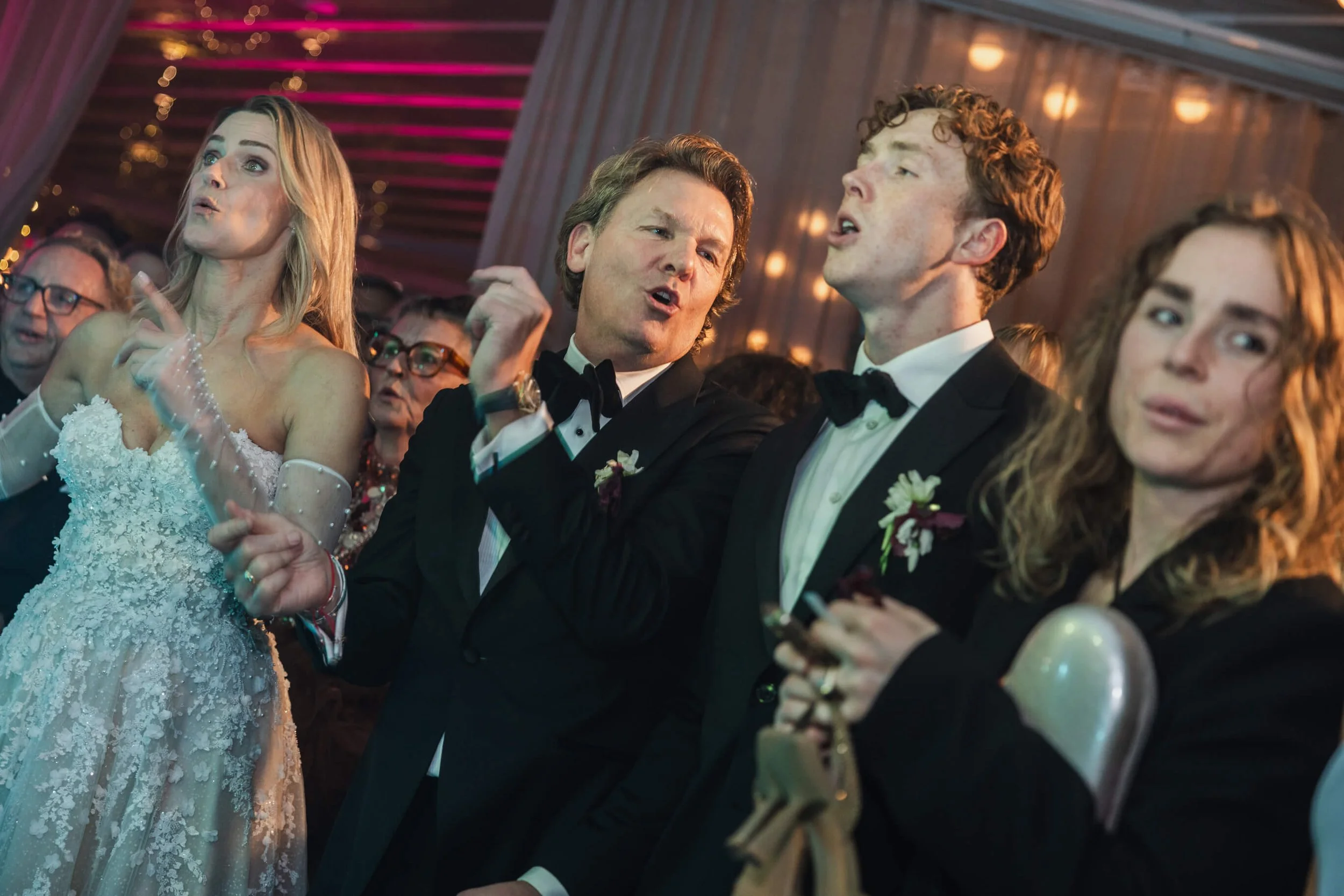 Couple singing alongside their children and guests during the late-night Café Opera celebration