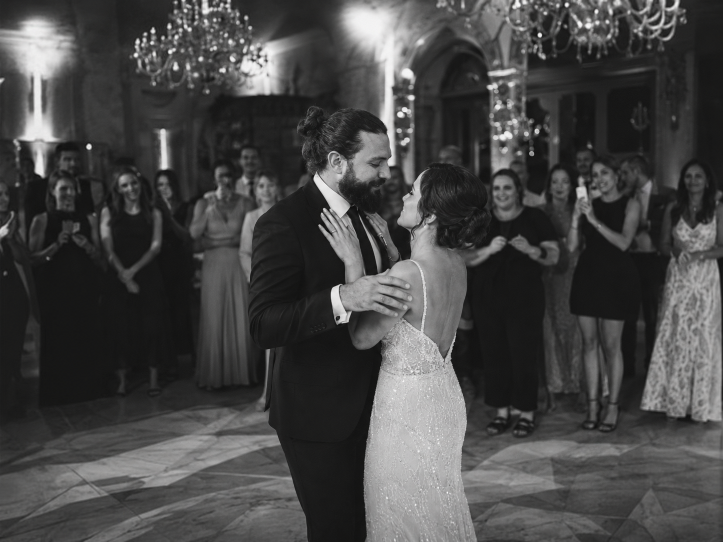 “Grand Hotel Tremezzo first dance during elegant black and white wedding reception with emotional evening atmosphere and guests watching in Lake Como”