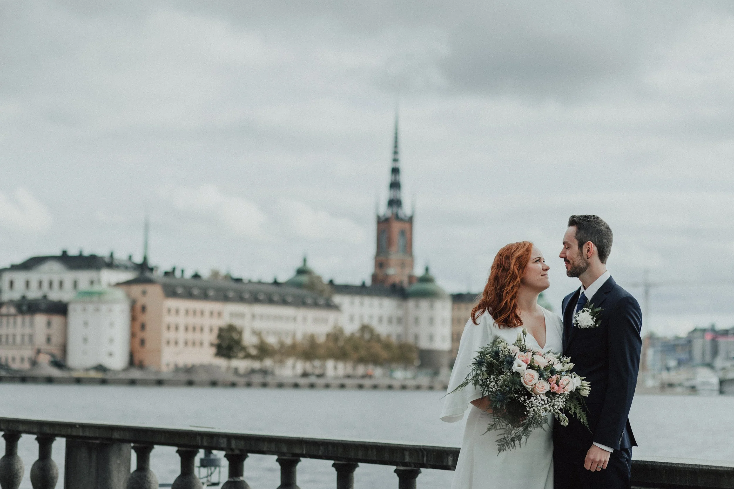 Autumn wedding portraits at Stockholm City Hall with soft cloudy light, Stockholm waterfront views and natural documentary wedding photography at Stadshuset, Sweden.