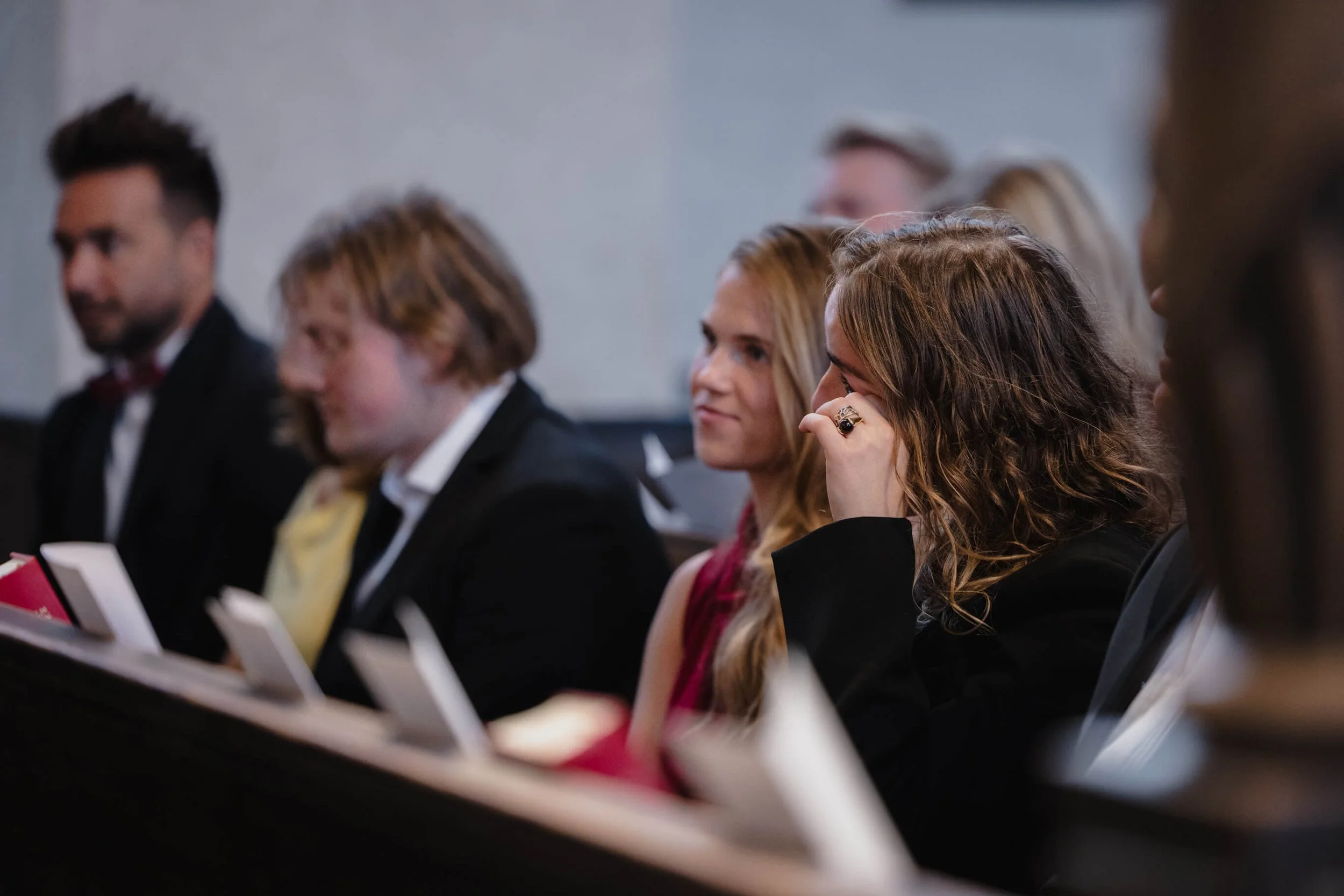 Young wedding guest becoming emotional during the ceremony