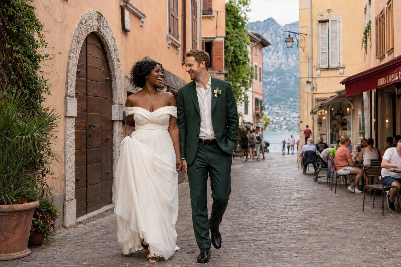 Bride and groom walking through the charming old town of Riva del Garda during a Lake Garda wedding portrait session.