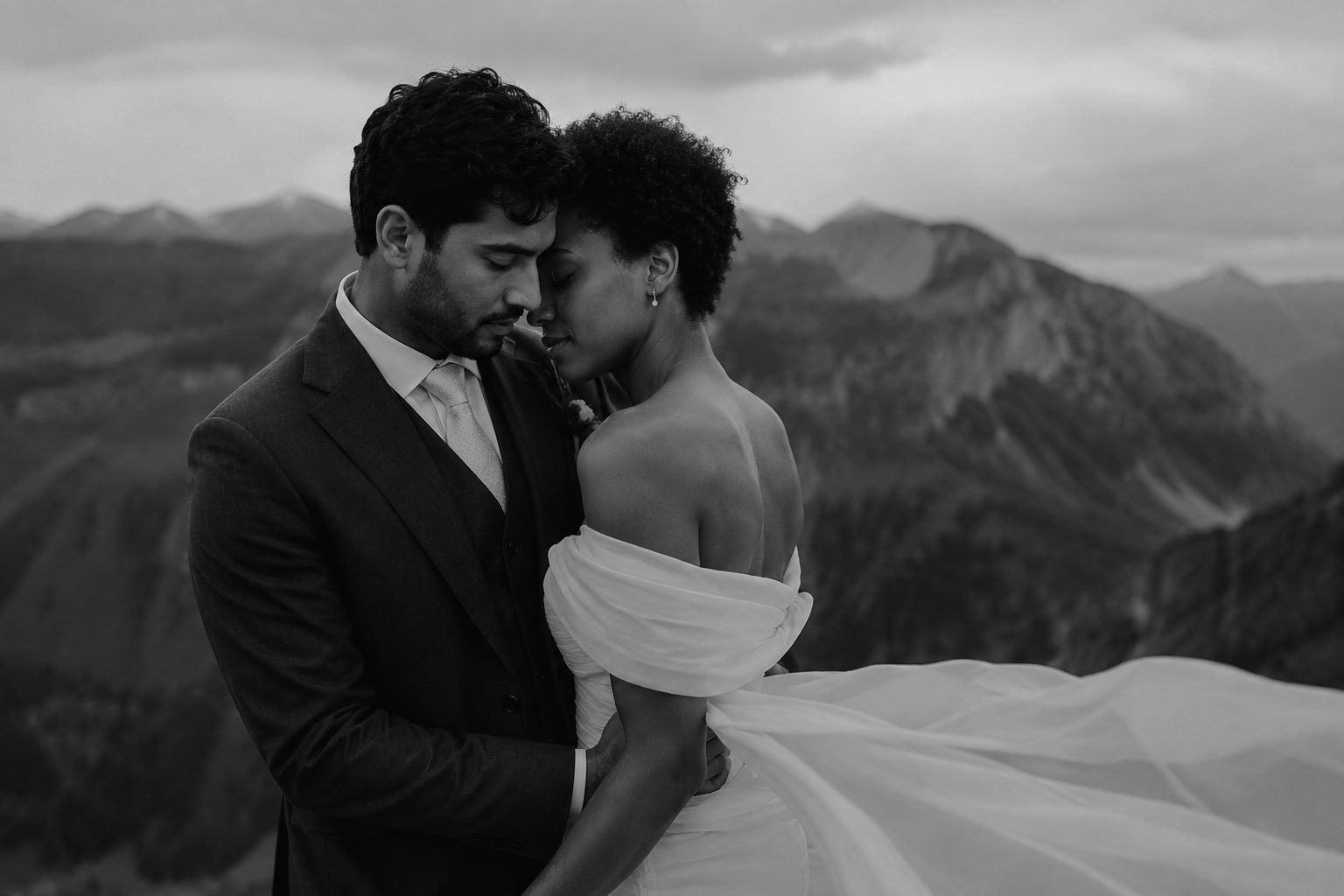 Bride and groom sharing an intimate portrait in the Dolomites with dramatic alpine mountains in the background.