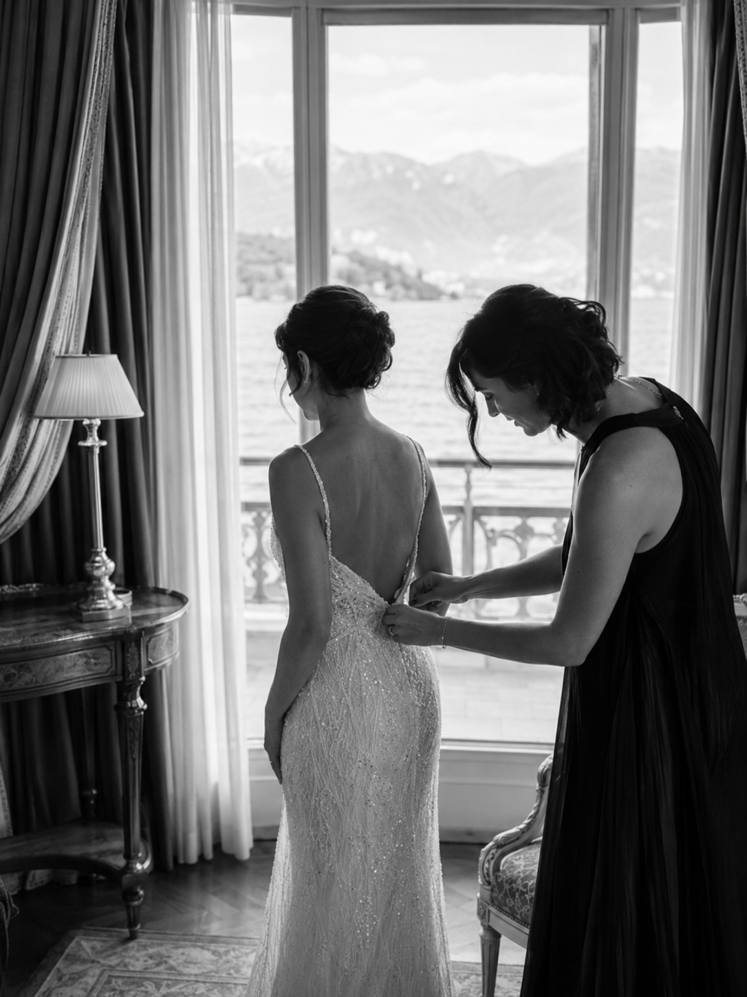 Black and white getting ready moment at Grand Hotel Tremezzo with groom adjusting his tie before the Lake Como wedding ceremony.