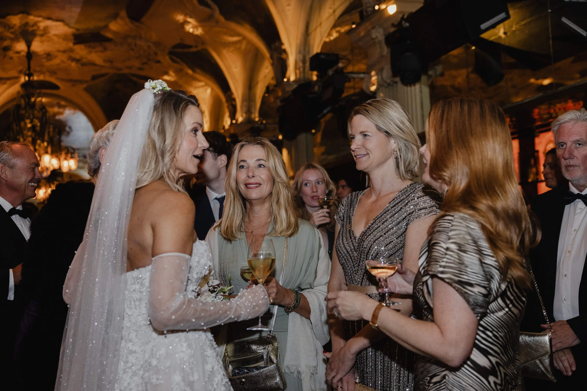 Bride greeting friends during the reception inside Café Opera