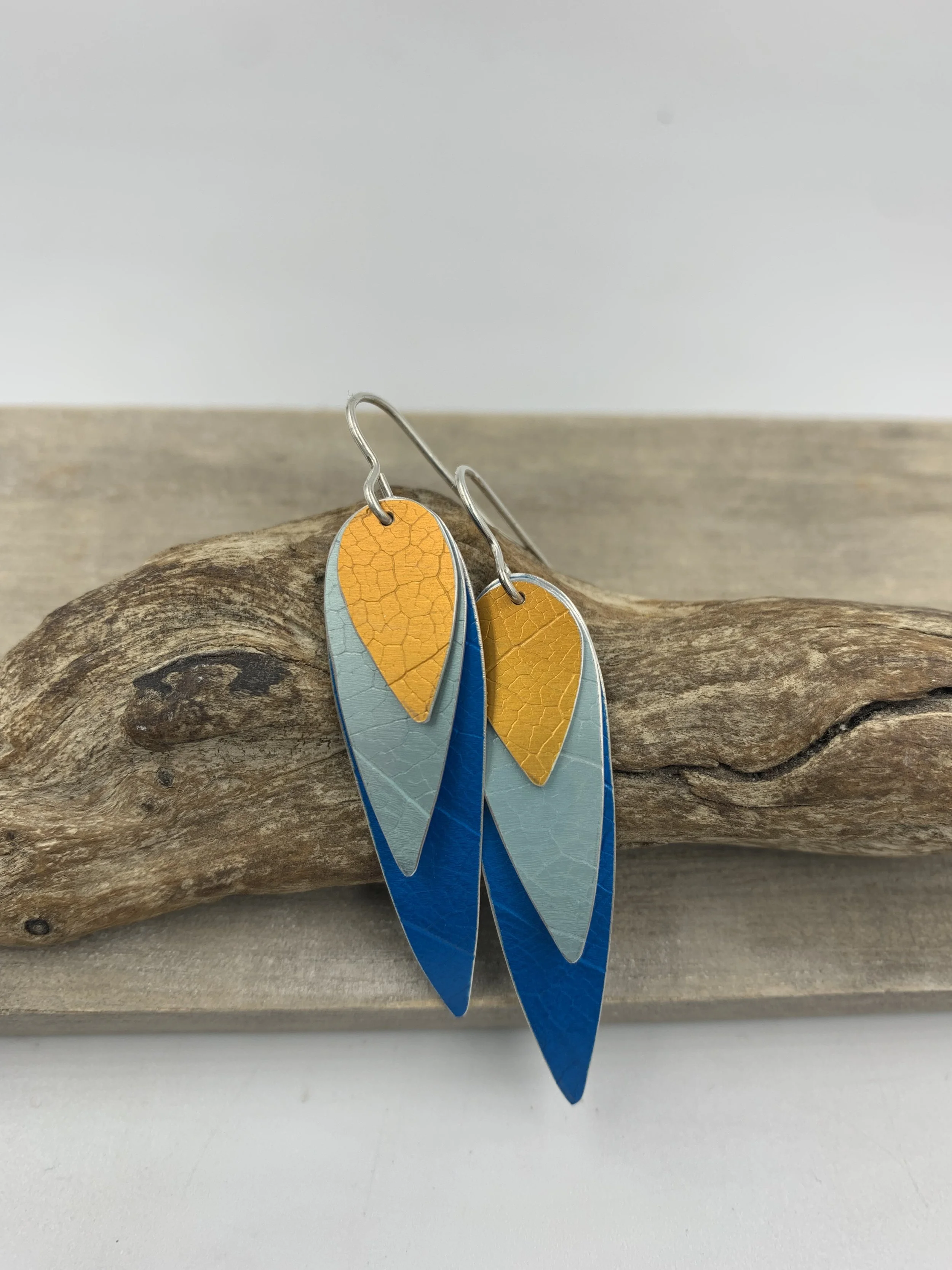 three layered parrot wing earrings blue teal and orange