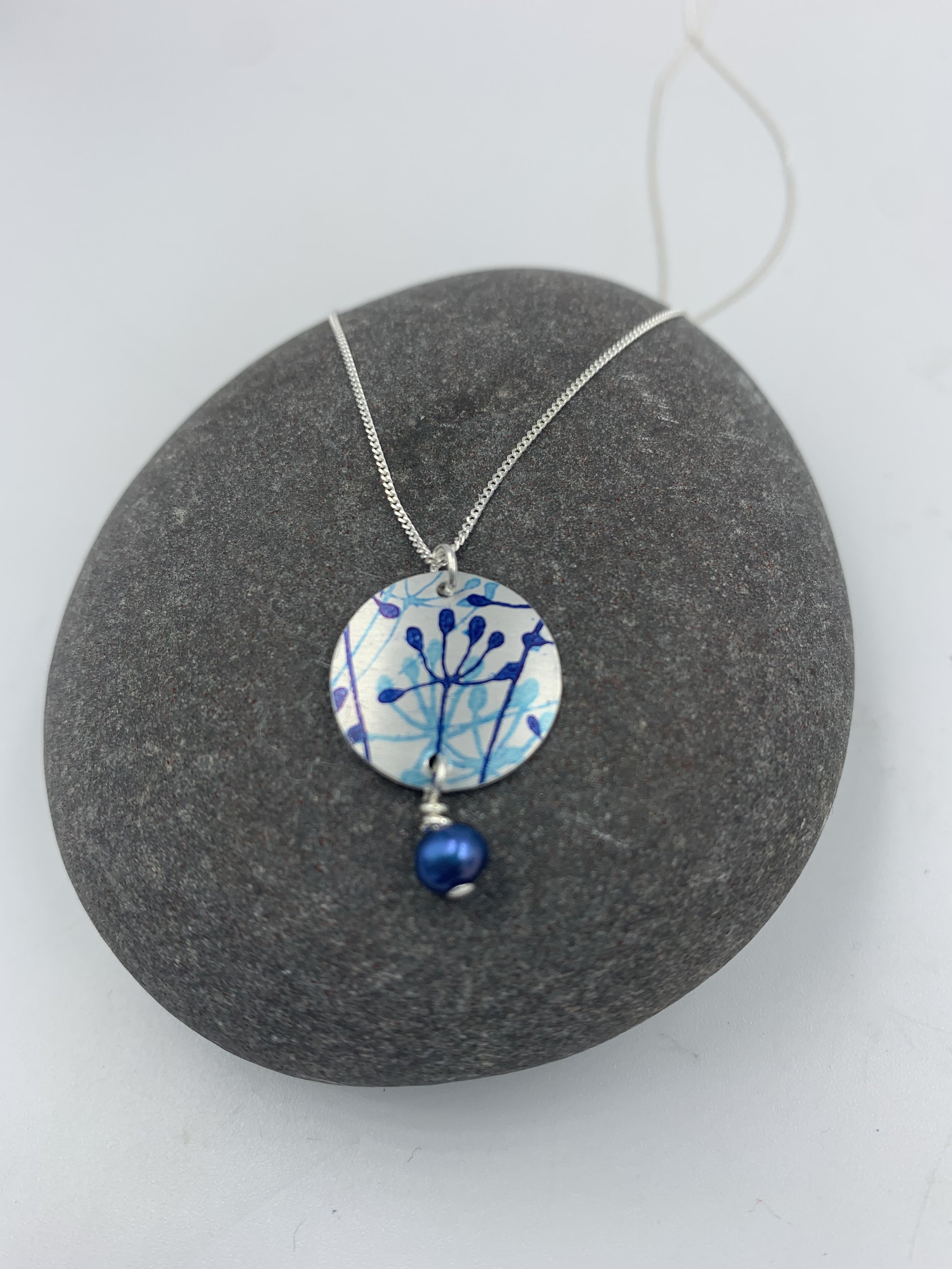 silver cow parsley print circle necklace with blue pearl