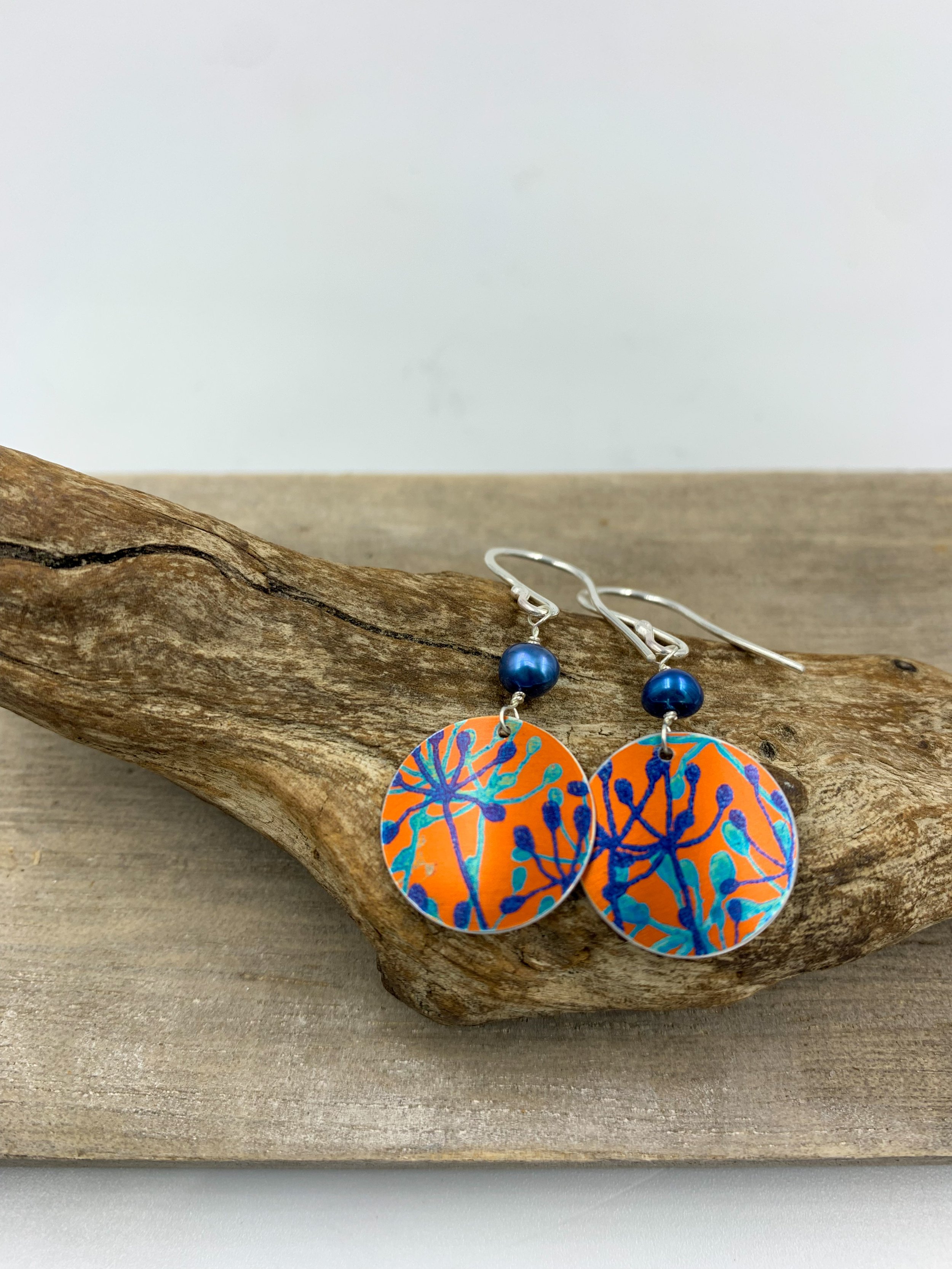 orange cow parsley print circle earrings with blue pearl