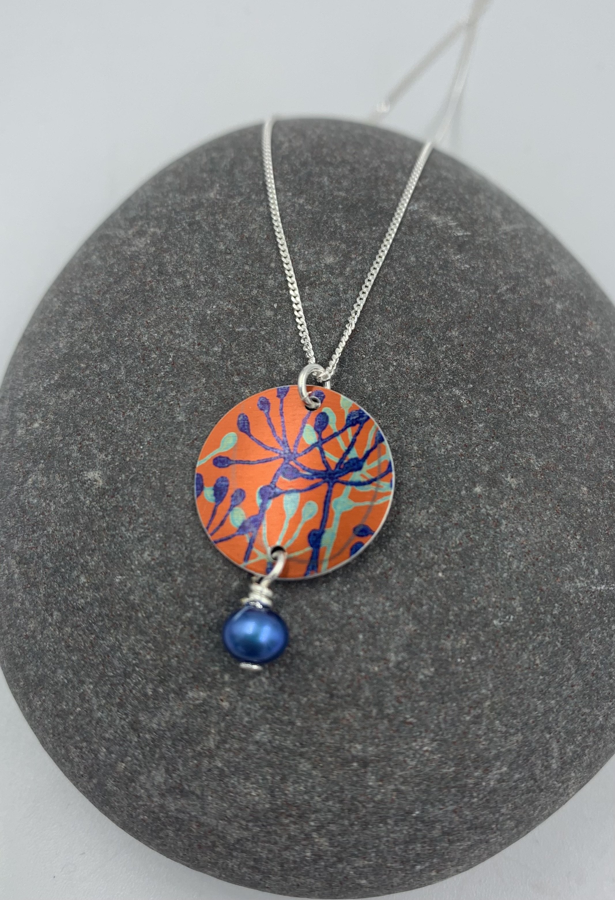 orange cow parsley print circle necklace with blue pearl