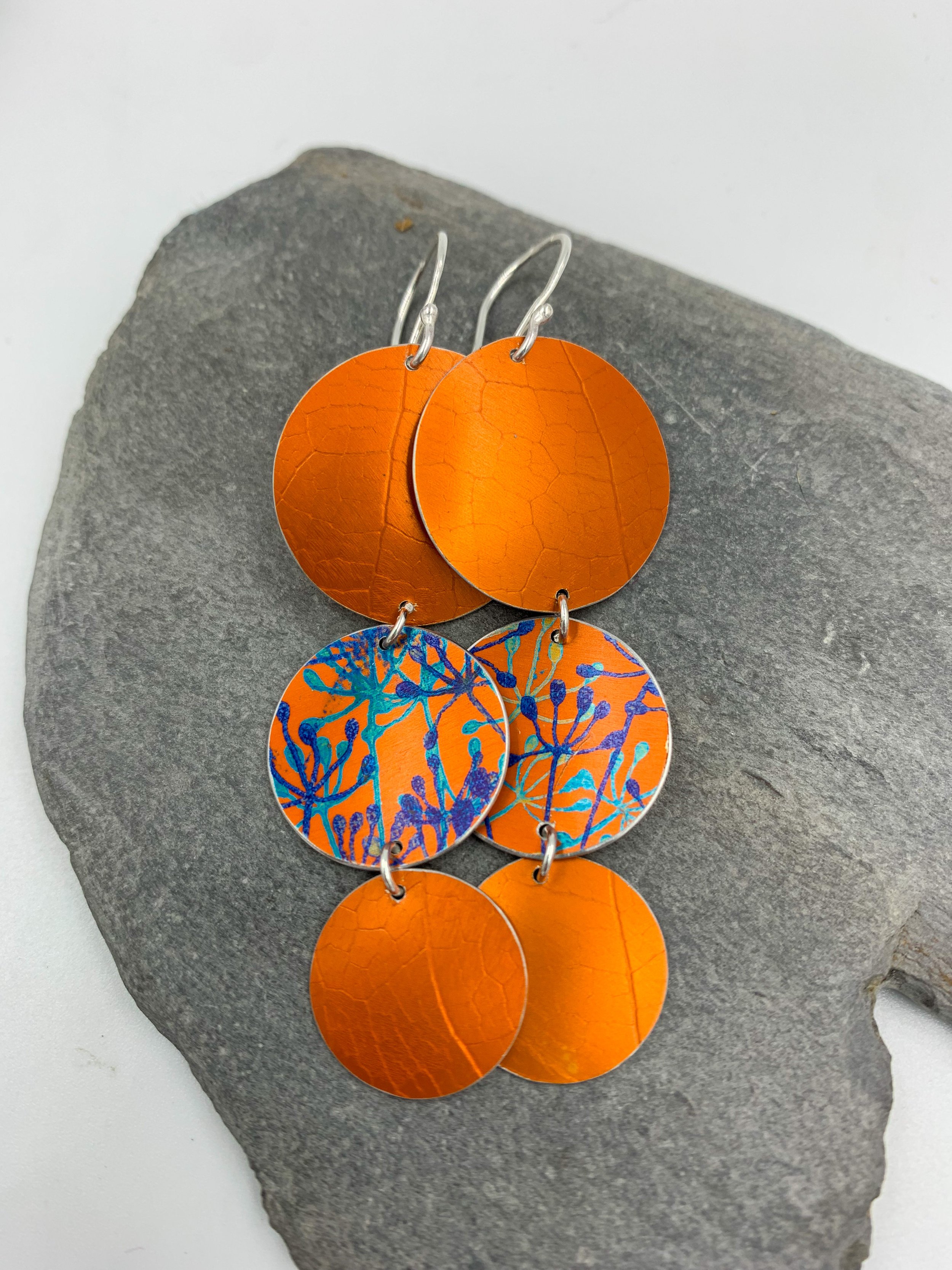 leaf textured 3 circle orange dangly earrings with cow parsley print