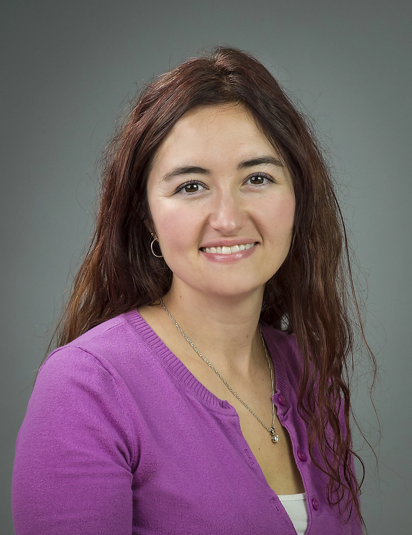 Jennifer Criso, daily money manager, headshot, Home Finance Care owner, in a purple sweater with long hair and earrings.