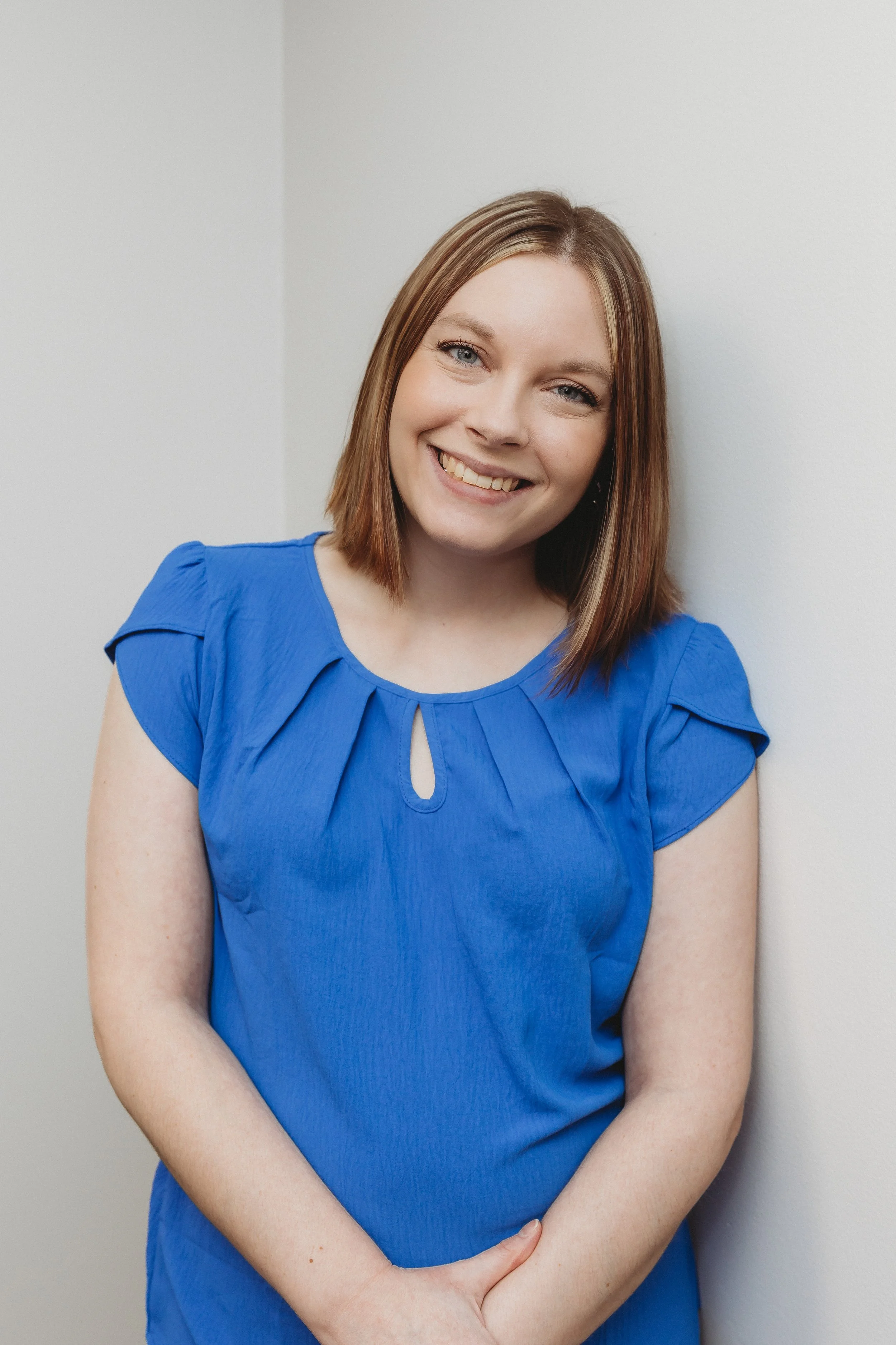 Natalie Heinz smiling in a blue professional shirt
