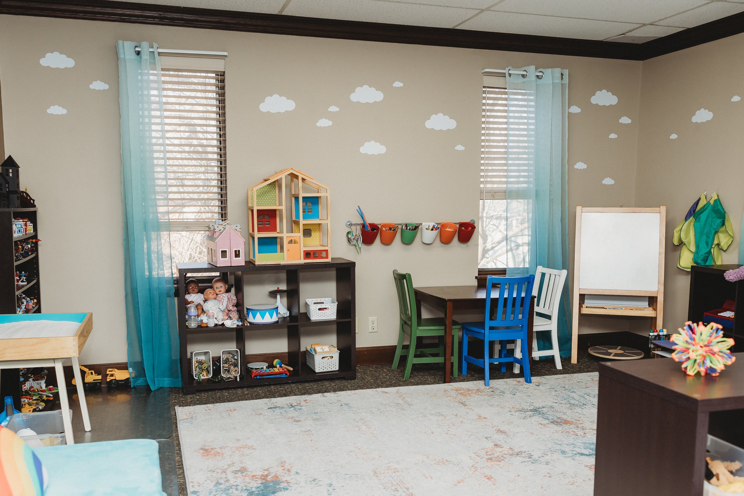 Play Therapy Room with lots of colors and toys organized on shelves