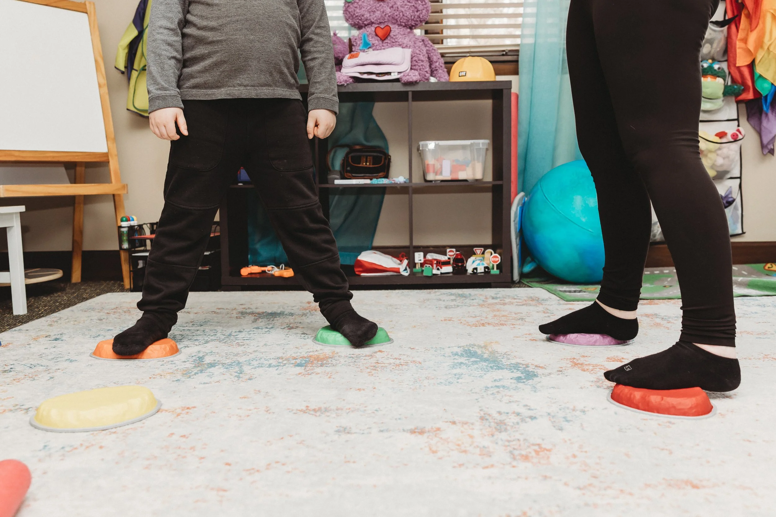 child and therapist on obstacle course to demonstrate ADHD movement and sensory needs in play therapy and co