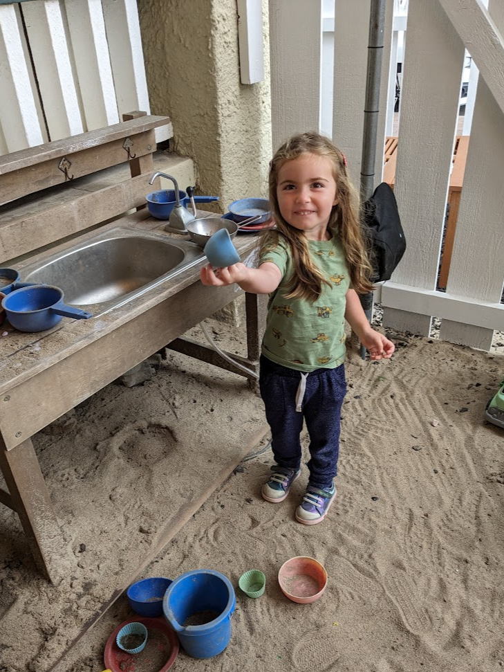 Girl playing with sand. 