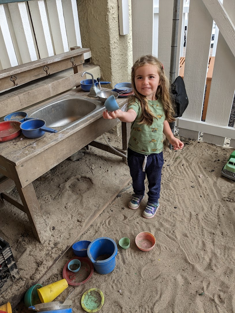 Girl playing with sand.