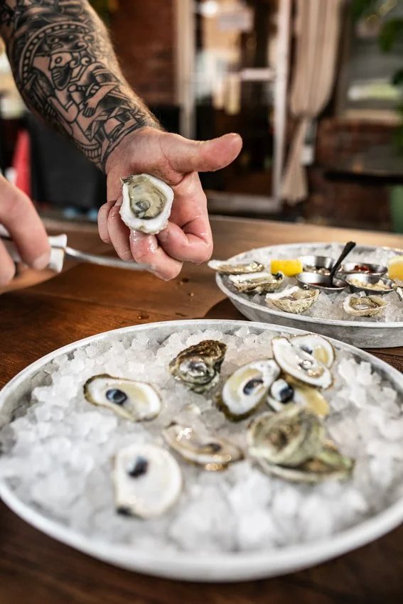 a person shucking oysters