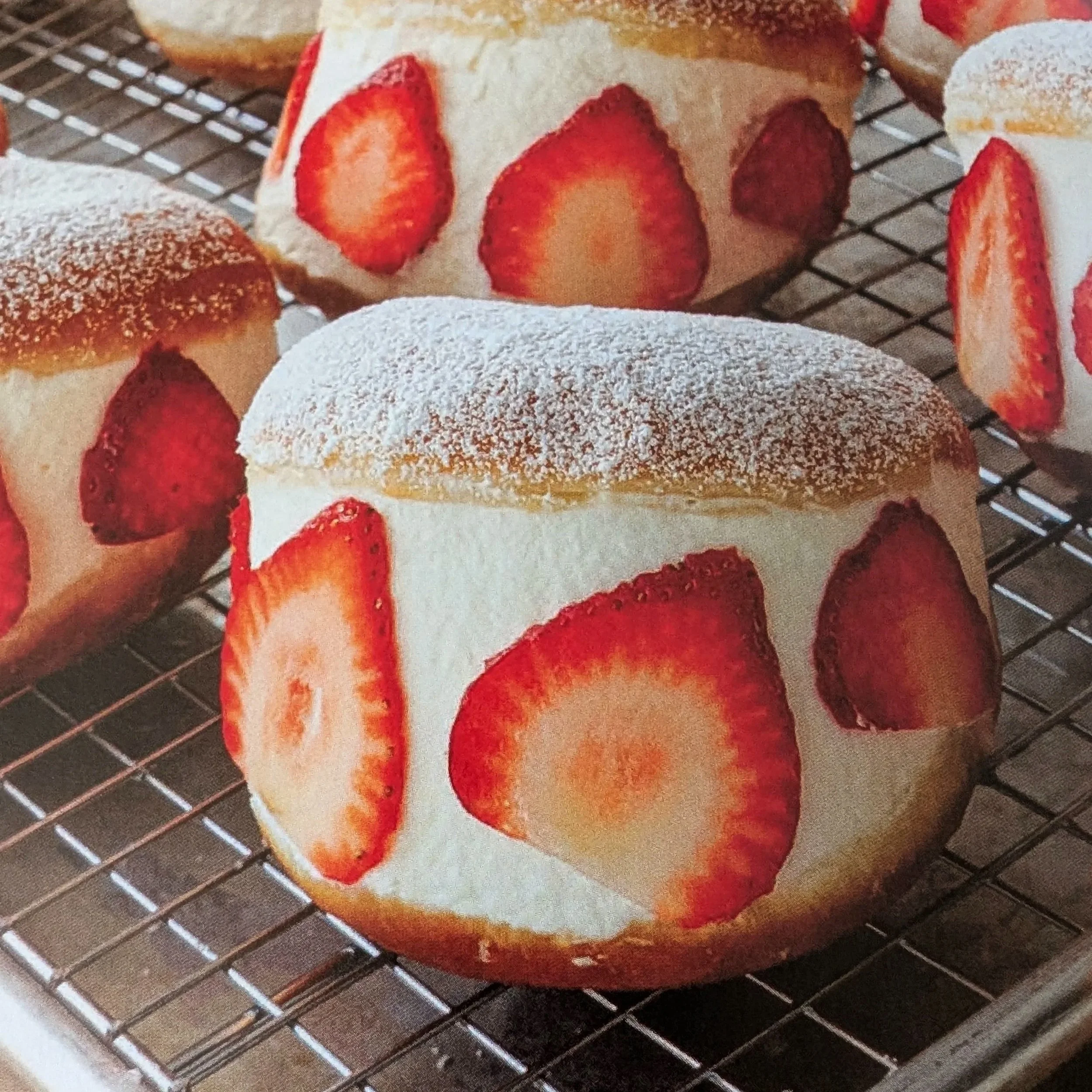 Milk cream doughnuts, fat with cream and stuffed with strawberries