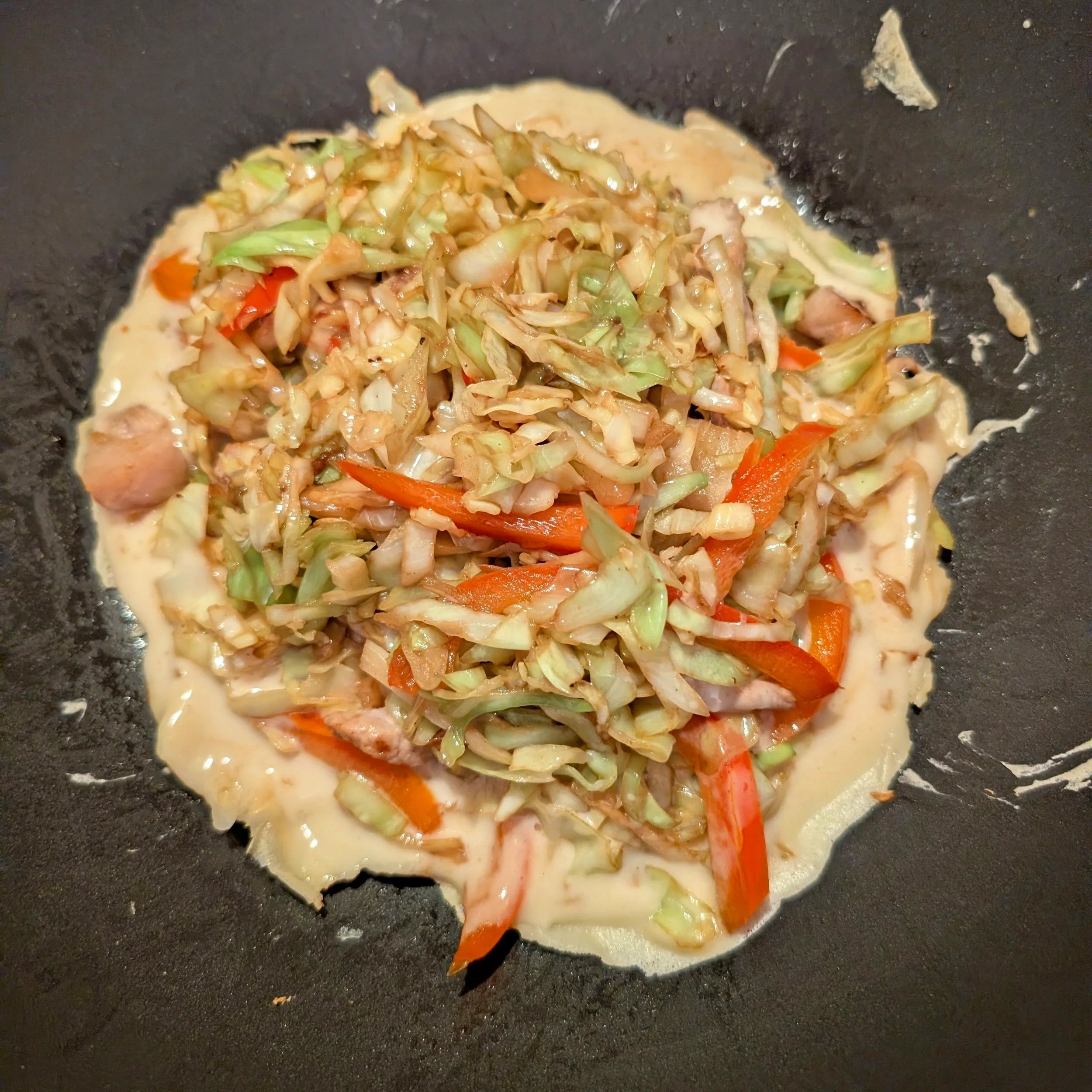 The mixture and pancake together cooking for okonomiyaki