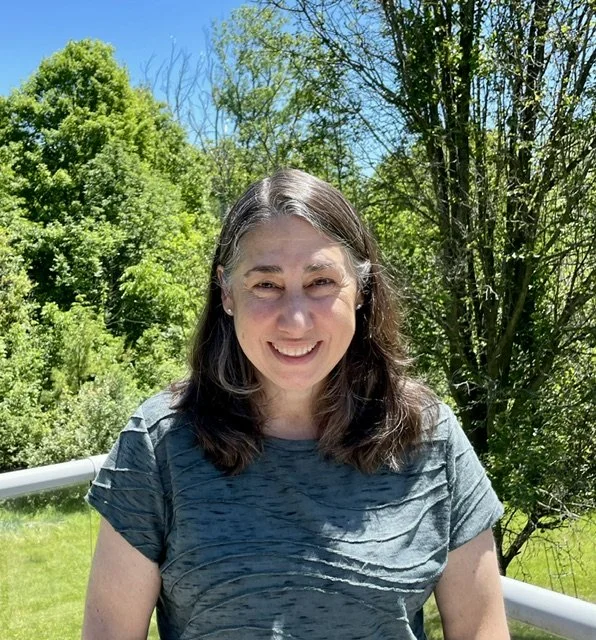 Julie Artinian Callaway standing outside with a welcoming smile.