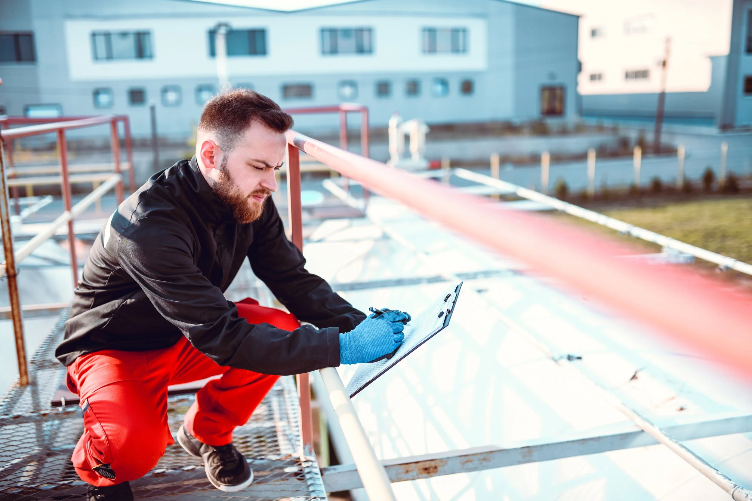 Person on commercial rooftop inspecting fire system