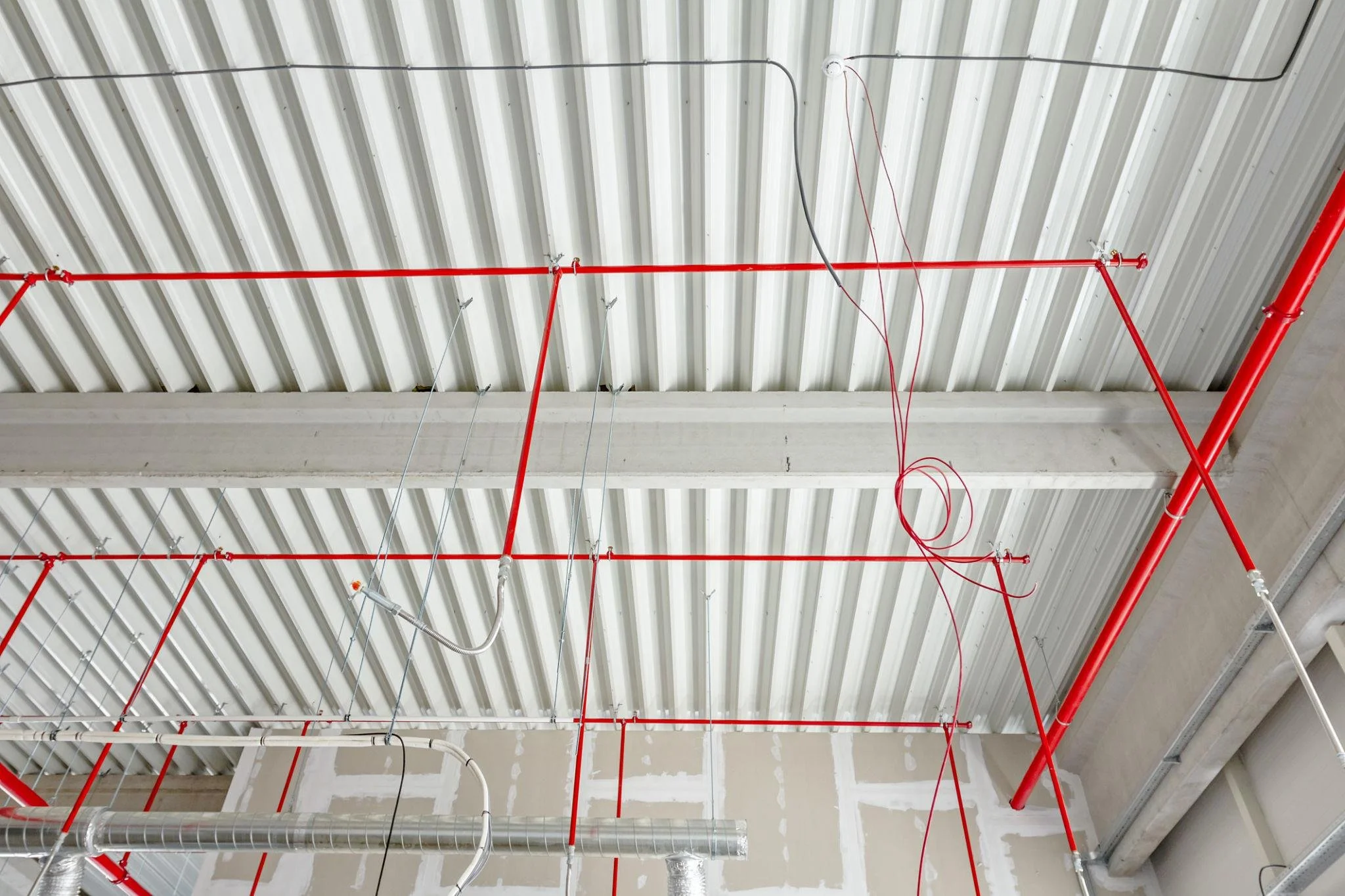 Fire sprinkler system installed in commercial building ceiling