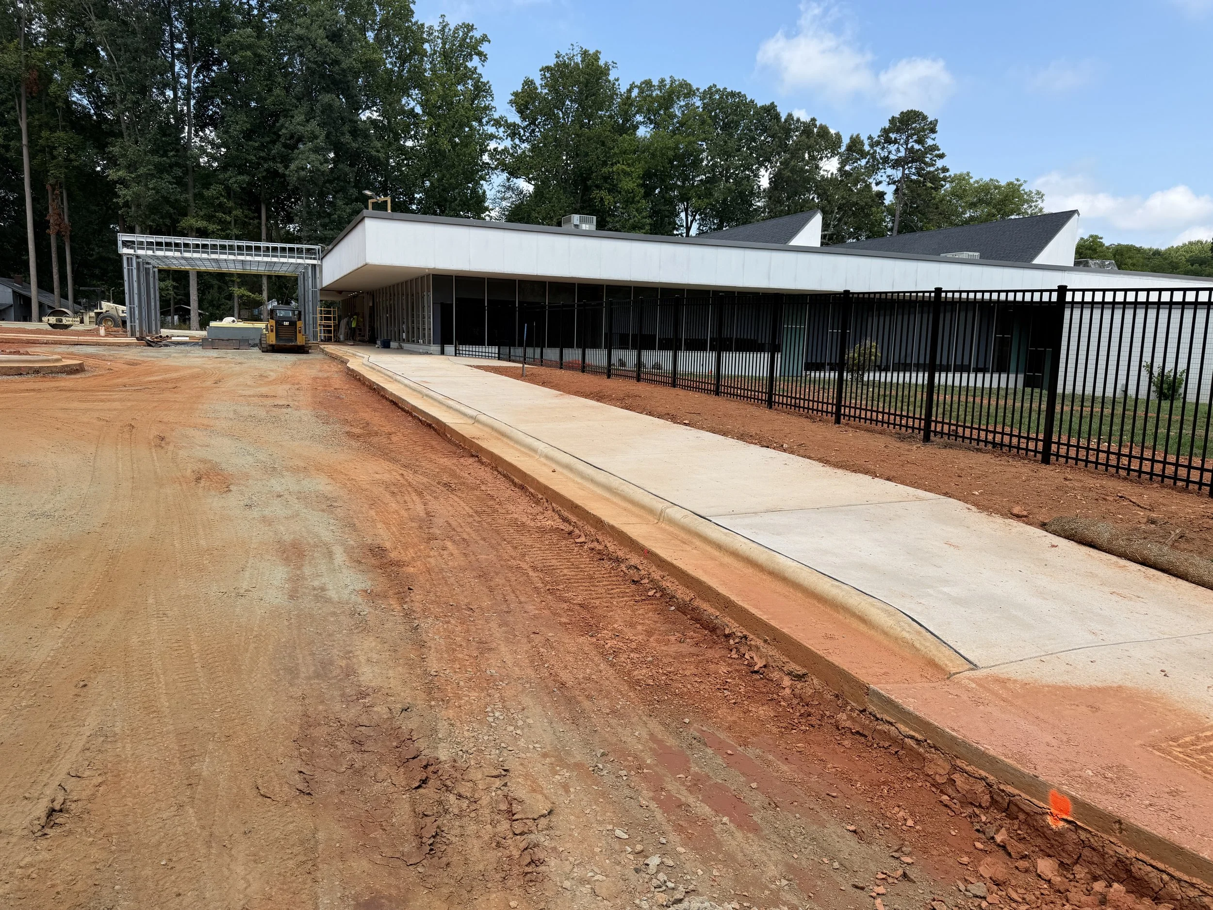 Main sidewalk and new fencing