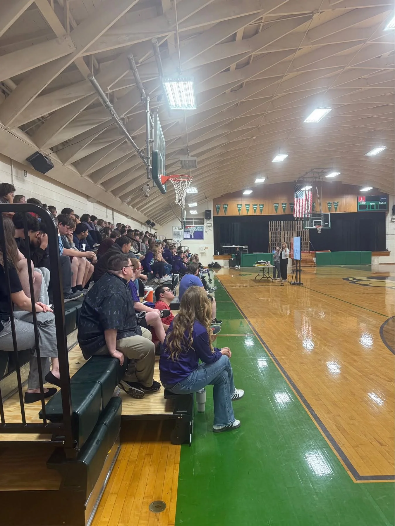  Students gather in the gymnasium, eager to learn about career opportunities in renewable energy and archaeology during Lightstar’s educational outreach event. 