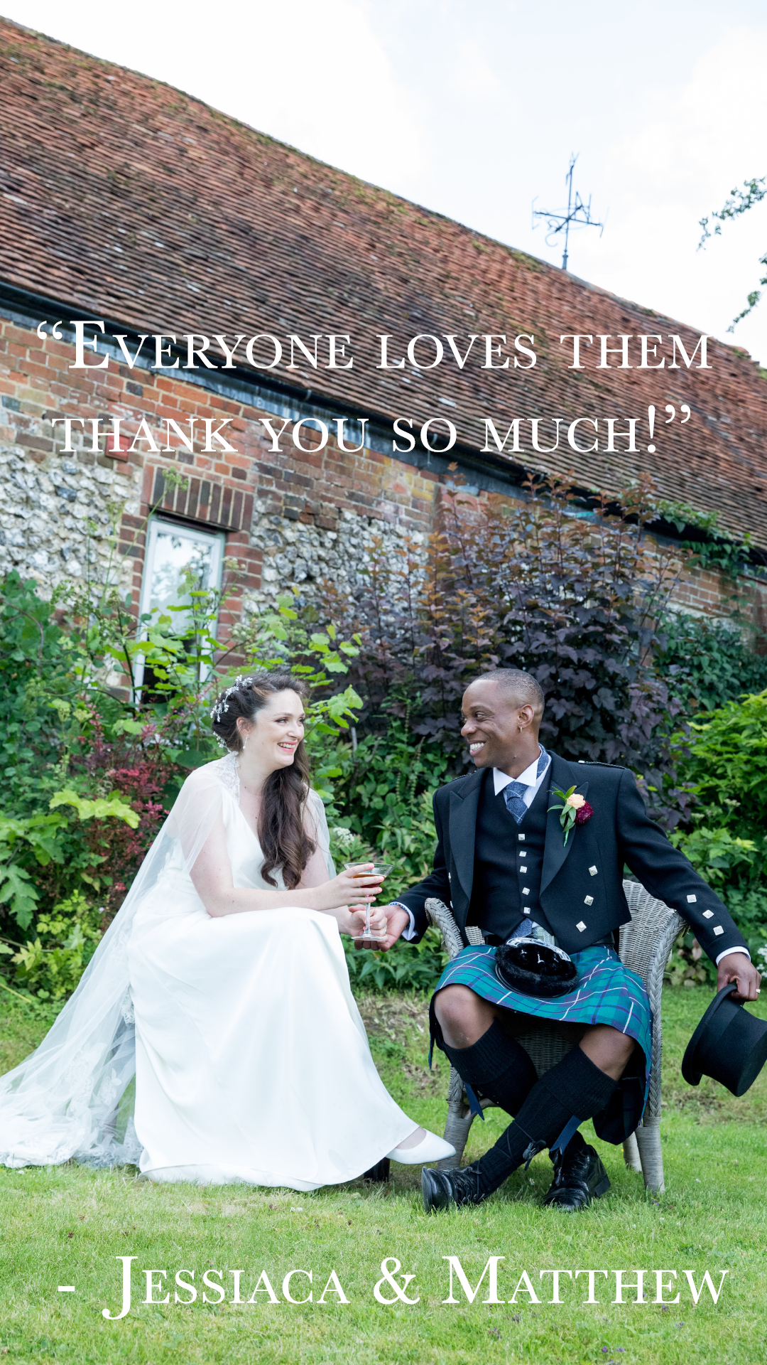 A wedding photo of a bride and groom sitting together on grass in a garden, smiling and holding glasses. The bride is in a white wedding dress, and the groom is in traditional Scottish kilt and jacket. The background features a brick house with overg