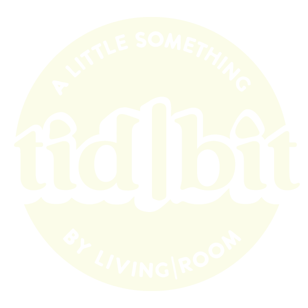 Logo with the text "tidbit" in large letters, surrounded by the phrases "A LITTLE SOMETHING" at the top and "BY LIVING ROOM" at the bottom.