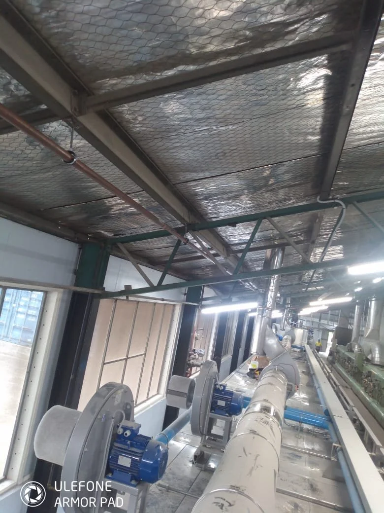 Industrial pipeline system with motors and metal framework inside a facility.