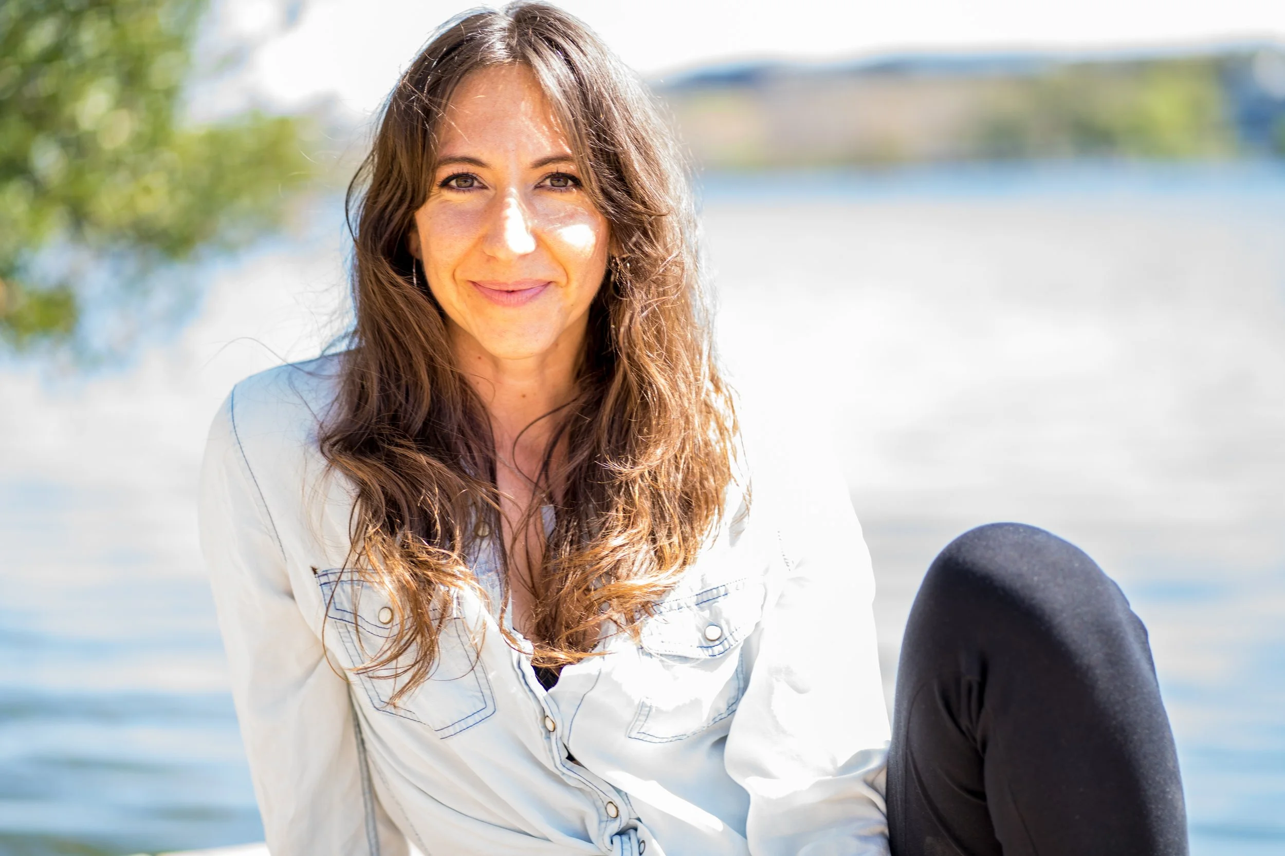 Somatic Relationship Educator sitting in nature teaching embodiment and nervous system awareness