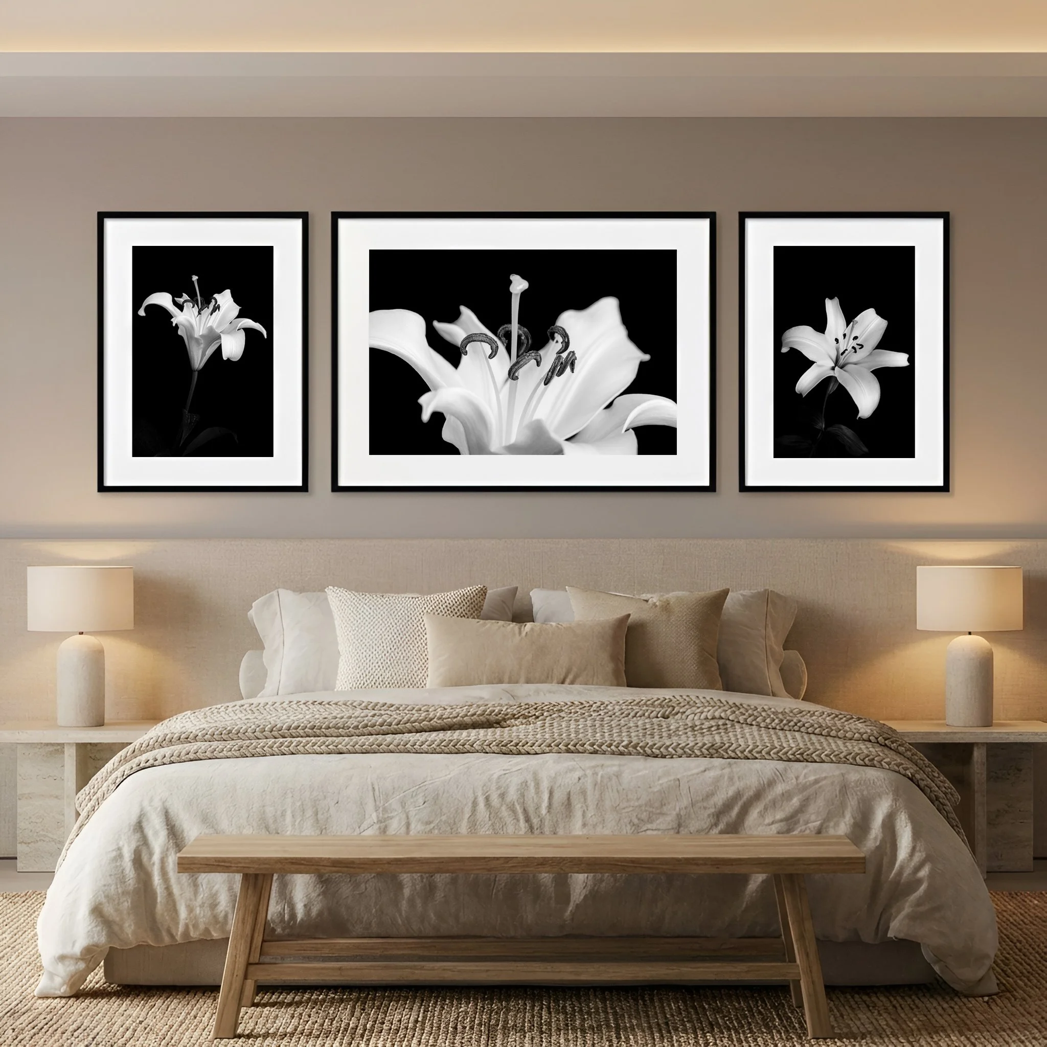Triptych of three framed lily photos hangs above the bed of a modern beige bedroom.