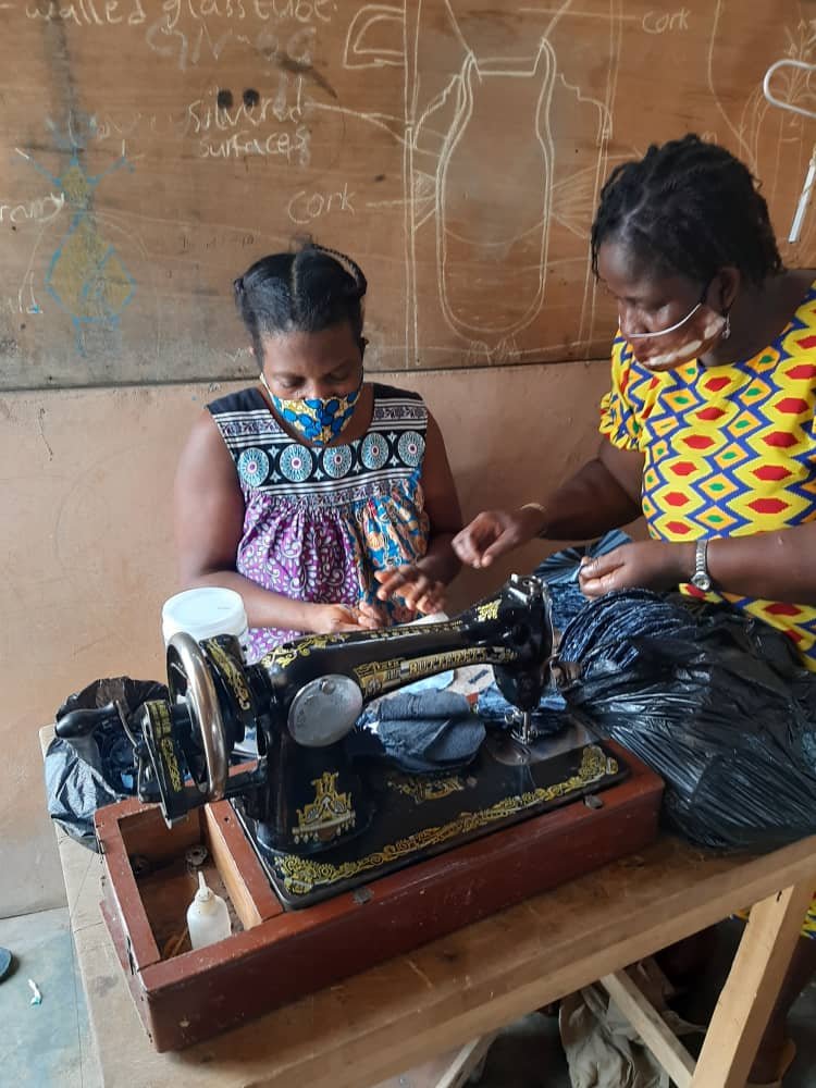  Artisans at the MFI Foundation Sewing Upcycled Denim Bags 